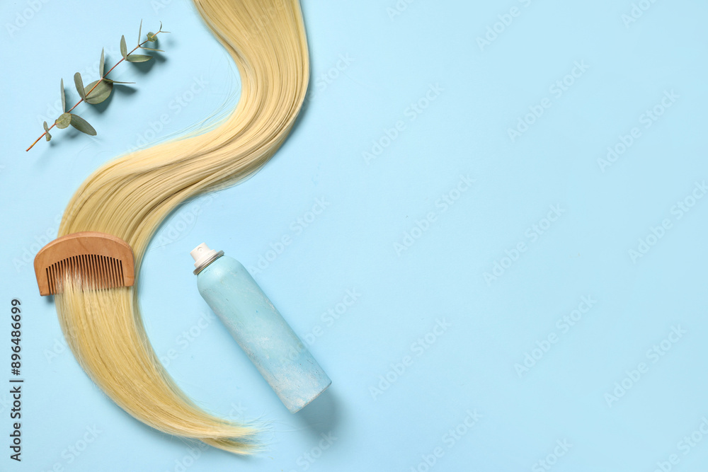 Hair spray with strand and comb on light blue background with space for text