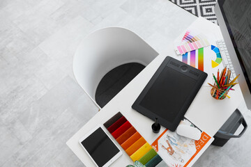 Sticker - Graphic designer's workplace with tablet and palettes in office, top view