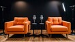 © Chaudhry - two orange sofa chairs and microphones interior in podcast or interview room on dark background with spot lights to chairs created with generative ai