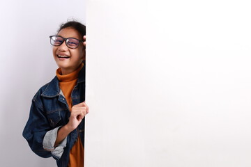 Portrait of young nice attractive lovely pretty glad excited cheerful cheery positive girl demonstrating copy space board ad isolated over white background