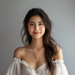 © Carmen - Portrait of beautiful Asian young woman with white dress, studio shot gray background, beauty and cosmetics concept