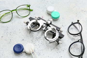 Wall Mural - Optical trial frame with eyeglasses and set for contact lenses on white grunge background