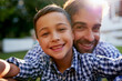 © Sanc/peopleimages.com - Selfie, father and son with portrait outdoor in garden of home for profile picture update or happy memory. Photography, dad and child with smile in backyard of house for bonding and social media post