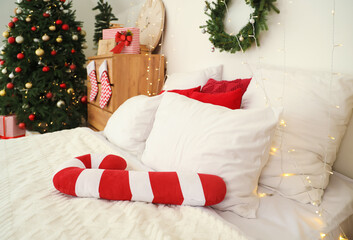 Wall Mural - Bed with candy cane pillow and Christmas lights in bedroom