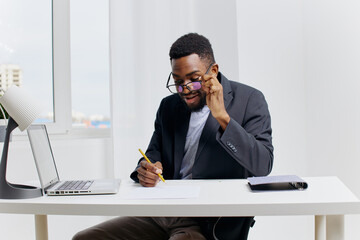 Business professional working on important documents at desk with laptop and pen