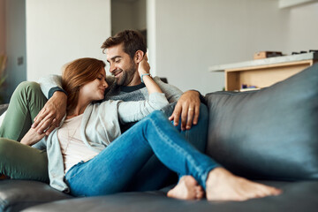 Poster - Couple, smile and relax on sofa in house for comfort, love and bonding time together with trust and care. Man, woman and holding hands in living room for connection, peace and support on weekend