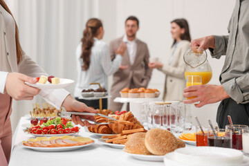 Wall Mural - Coworkers having business lunch in restaurant, closeup