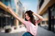 © BillionPhotos.com - Beautiful happy young woman posing on the street.