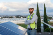 © Alan - portrait of a confident engineer looking at camera, technician standing between solar panels, concept of a professional on renewable energy posing with confidence