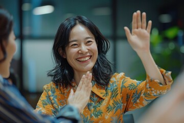 Wall Mural - Close-up of a woman giving a high-five to a colleague in a meeting room, celebrating success, positive work environment, Portrait half-body, hyper-realistic, high detail, photorealistic, Japanese