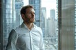 © Herlita - A businessman looking out a window in a high-rise office building
