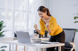© David - Portrait of a happy excited asian businesswoman holding laptop working with computer with happy face in the workplace office.