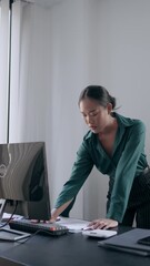 Wall Mural - Businesswoman working with data spreadsheet documents at workplace