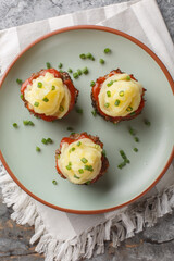 Sticker - Meatloaf muffins are a fun way to serve this comfort food with mashed potatoes on top closeup on the plate on the table. Vertical top view from above