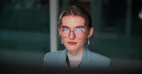 Face, woman and computer in office at night for overtime, deadline and online research as programmer or coder. Female person, employee and serious with glasses for software update and digital data