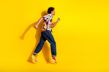 Poster - Full body portrait of nice funky young man jump run empty space wear shirt isolated on vibrant yellow color background