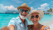 © worawut - Joyful seniors enjoying a sunny beach day, wearing hats and sunglasses, capturing memories with a selfie by the beautiful sea.