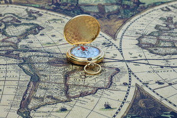 classic round compass on background of old vintage map