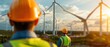 © Starkreal - Innovative Engineers Collaborating on Renewable Energy Project with Wind Turbines in Background