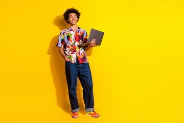 Sticker - Full body portrait of nice funky young man laptop empty space wear shirt isolated on vibrant yellow color background