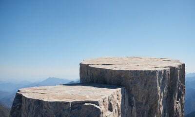 Two flat rock podiums on a mountain cliff against clear blue sky