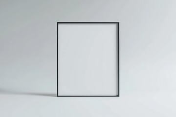 Poster - A minimalist black picture frame is displayed against a gray wall. The frame is empty, showcasing a blank center perfect for adding art or photos.