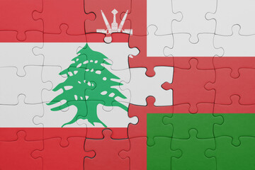 Wall Mural - puzzle with the colourful national flag of lebanon and flag of oman .