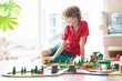 © famveldman - Kids play wooden railway. Child with toy train.