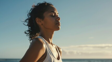 Wall Mural - A young Hispanic woman taking a break from her run to stretch, the ocean providing a serene backdrop. 