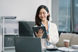 © NINENII - Businessman using laptop computer in office. Happy woman, entrepreneur, small business owner working online.