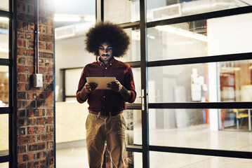 Wall Mural - Night, black man and tablet at office for networking, research and review with international client. Male designer, web development and tech at building for update, email communication and feedback