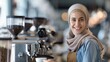 © Old Man Stocker - Smiling Muslim Barista in Modern Café. Smiling young Muslim barista wearing a hijab, working behind the counter in a modern café, ready to serve coffee.