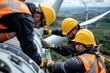 © Nena Photo - Group of construction workers wearing safety gear working on a wind turbine, showcasing teamwork and modern industrial practices in renewable energy projects.