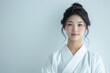 © anzodesign - Japanese woman in white kimono posing against a light background