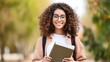 © Subin - Happy Indian girl in casual attire holding notebooks,