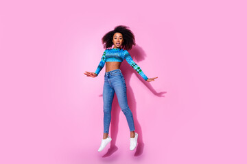 Sticker - Full size photo of lovely young lady jumping have fun dressed stylish blue garment isolated on pink color background