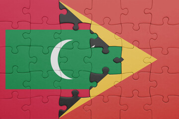 Wall Mural - puzzle with the colourful national flag of maldives and flag of east timor .