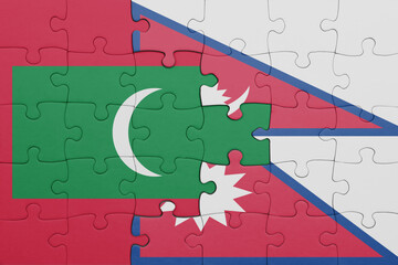 Wall Mural - puzzle with the colourful national flag of maldives and flag of nepal .