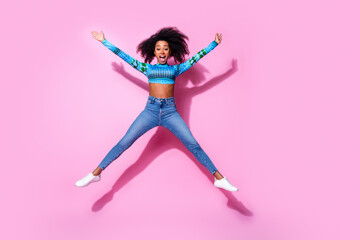 Sticker - Full size photo of lovely young lady jump excited spread hands legs dressed stylish blue garment isolated on pink color background