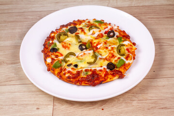 Wall Mural - Delicious pizza served on white plate isolated on wooden background