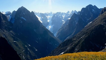 Poster - The mountains are covered in snow and the sun is shining brightly. The view is breathtaking and serene