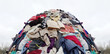 © annaspoka - textile pollution, fast fashion industry waste, old clothing cloth fabric garment trash garbage pile stack heap  background, concept of fast fashion industry tax and recycling