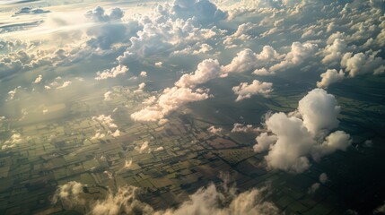 Wall Mural - Showcase an aerial view of cloud shadows moving across a landscape, painting the ground below in patches of sunlight and shade.