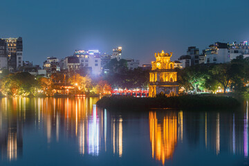 Wall Mural - Turtle Tower in Hoan Kiem lake. Illuminated Old quarter in Hanoi at night, Vietnam..