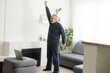 © Angelov - Online workout. elderly man doing exercise with online tutorial at home, panorama, free space
