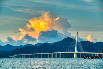 shenzhen bay highway cross-sea bridge under colorful clouds.