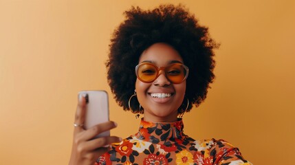 Canvas Print - Portrait of beautiful young black woman taking selfie.portrait of a pretty young afro american woman in retro style clothes smiling while standing and taking a selfie isolated over beige.