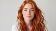 © Ace64 Studio - Closeup of happy attractive young woman with long wavy red hair and freckles wears stylish t shirt looks happy and smiling isolated over white background.