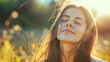 © Maciej Koba - Woman enjoying the sunlight with closed eyes in a serene outdoor setting