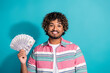 © deagreez - Photo of glad positive rich man wear trendy striped clothes hold money cash isolated on cyan color background